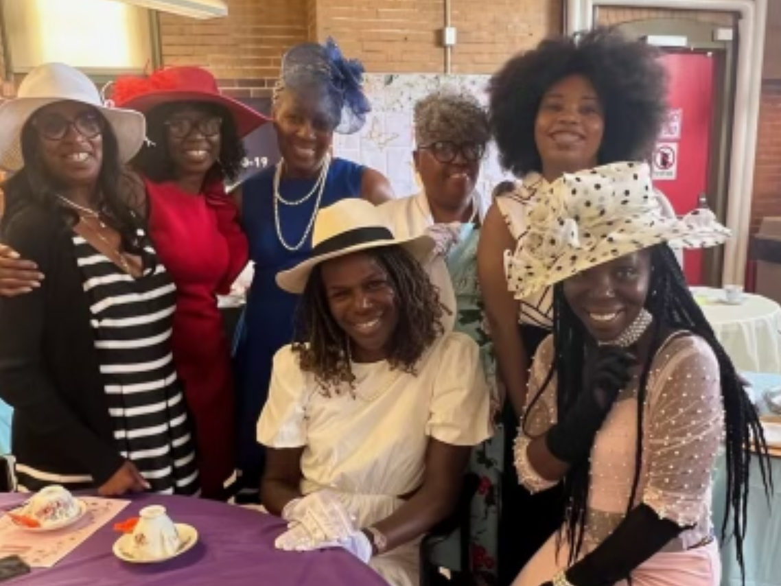 Dr. Ala Stanford (seated center) with members of Firehouse Active Adult Center, and Sarah McFadden, SavannaCare, at "Tea Party: Women Helping Women".