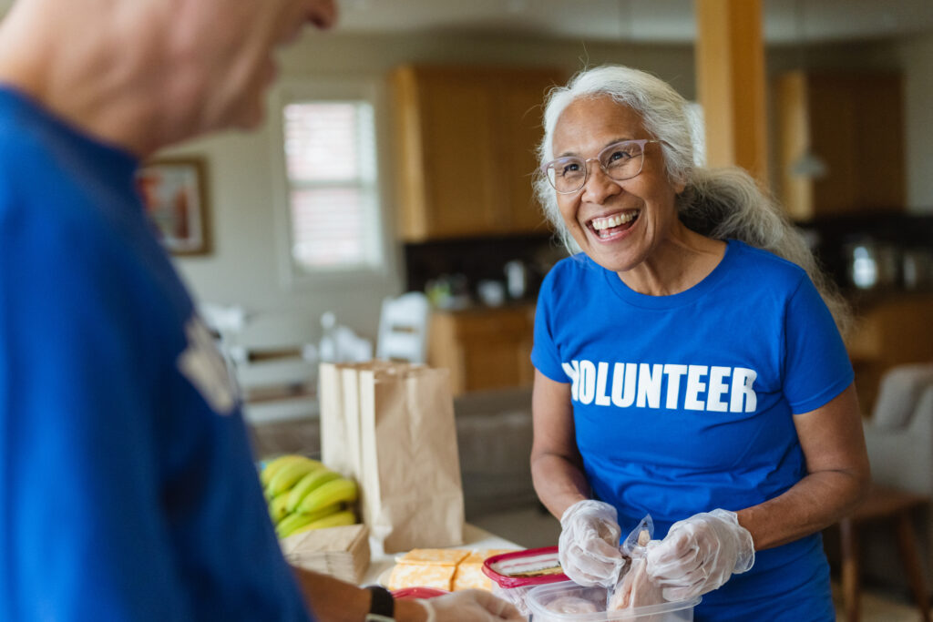 Cheerful mature adult woman volunteering for community service center