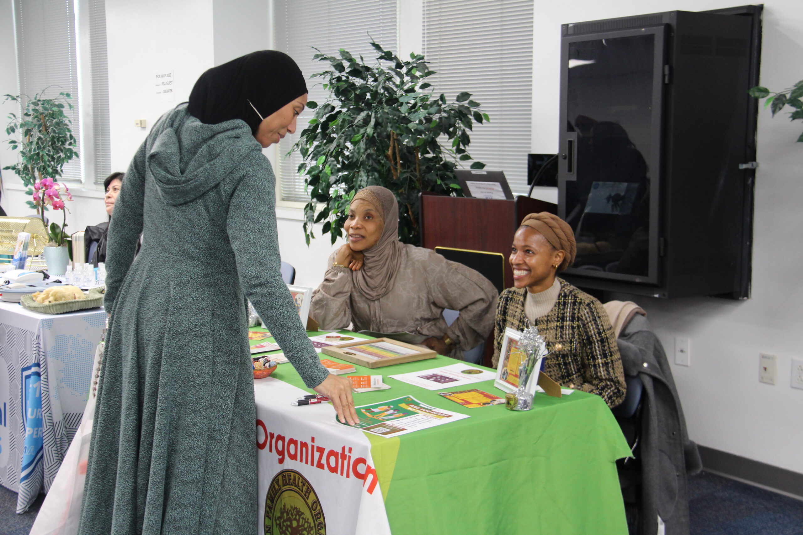 Three women smiling at Engage in Aging event.