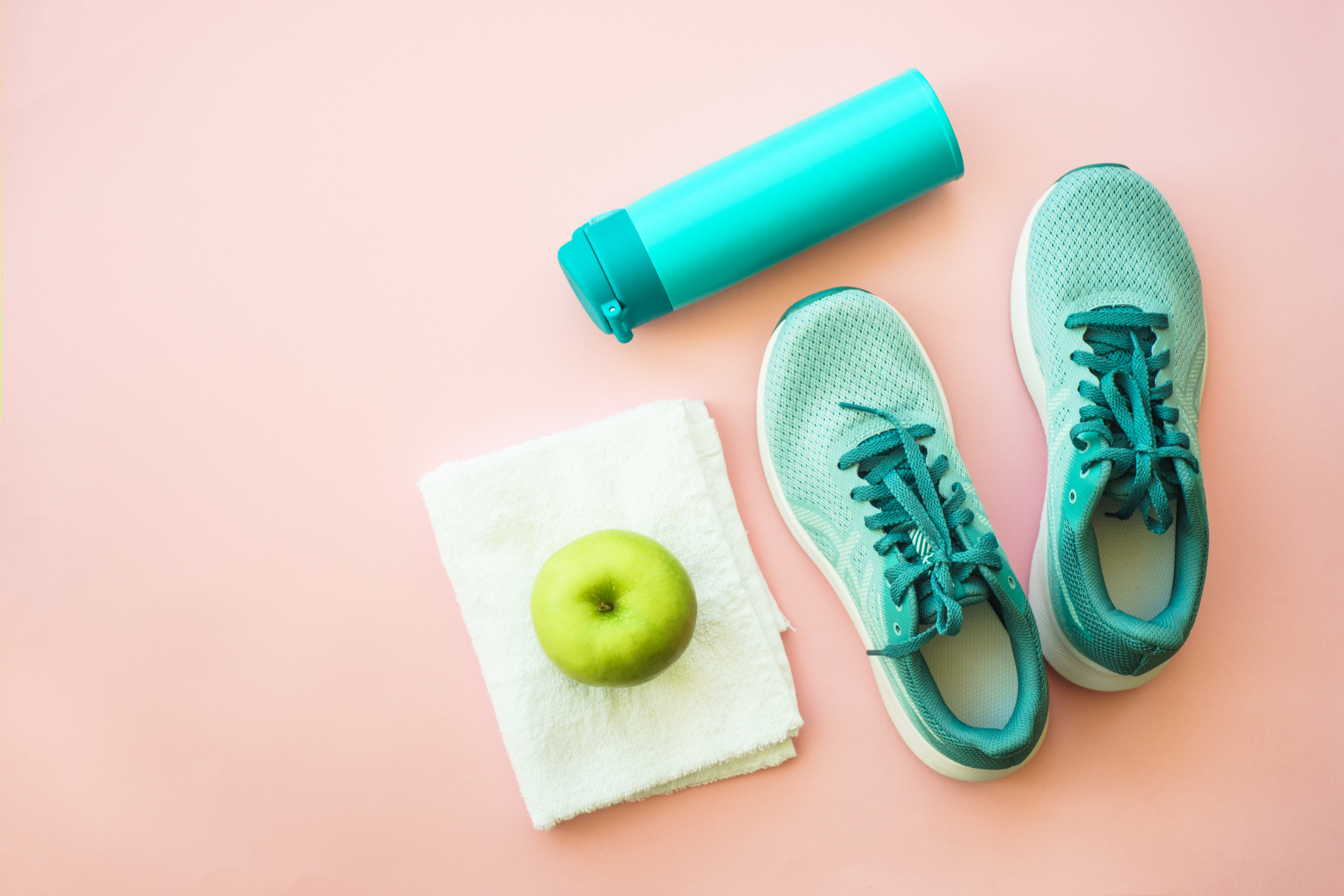 Workout and healthy lifestyle concept. Fitness equipment and apple. Flat lay with copy space.
